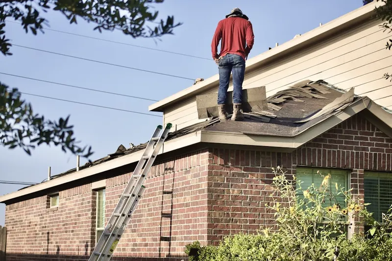 Professional roofer working on a residential roof in Sunset Beach